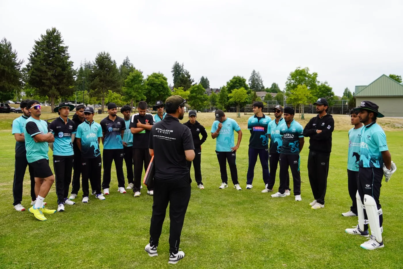 Stallions coach briefing a squad of players on the field